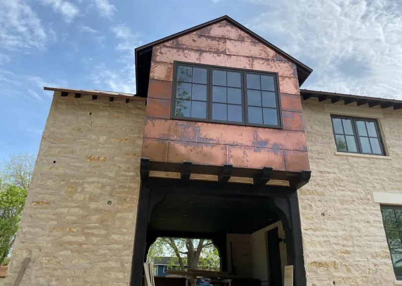 Copper metal panel facade on a stone building for Roof Repair in New River