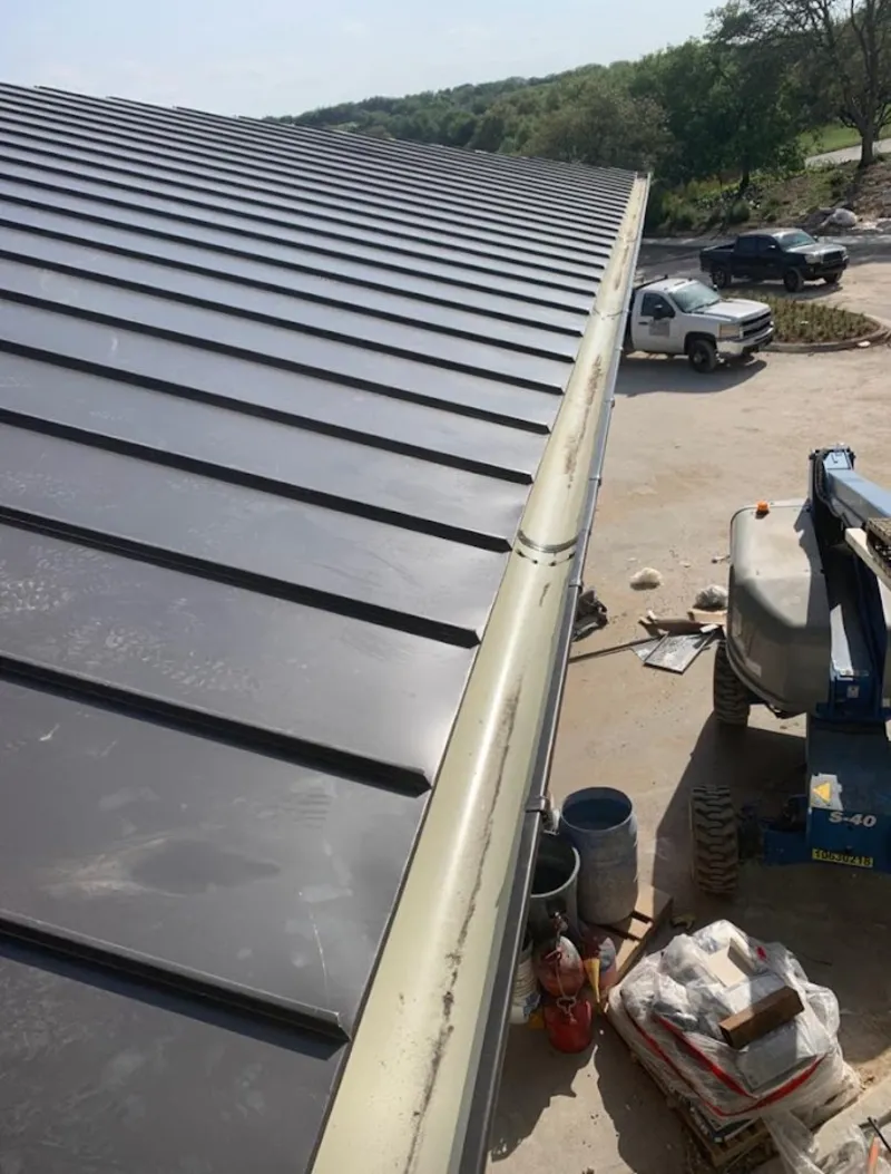 Standing seam panel and gutter detail on a metal roofing jobsite in New River